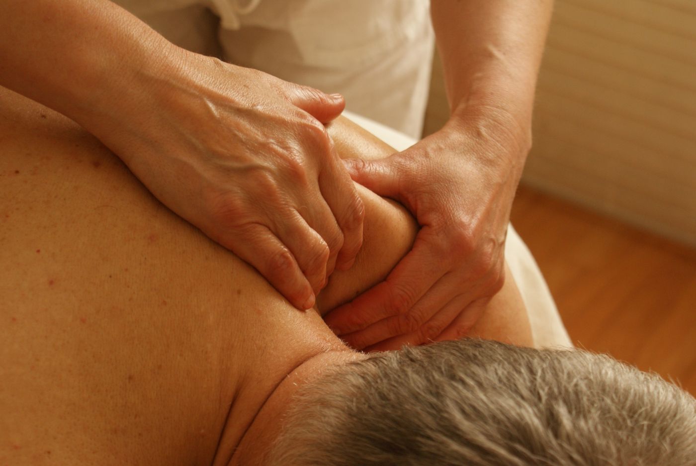 Firm deep-tissue work on a shoulder